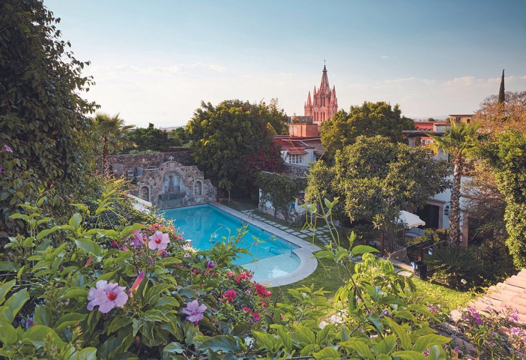 Scenic view of a tranquil garden with a swimming pool at Laja Spa, one of the best spas in San Miguel de Allende.