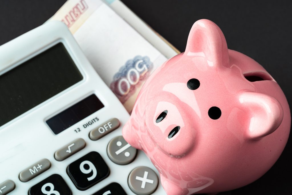 Calculator with piggy bank and money russian roubles