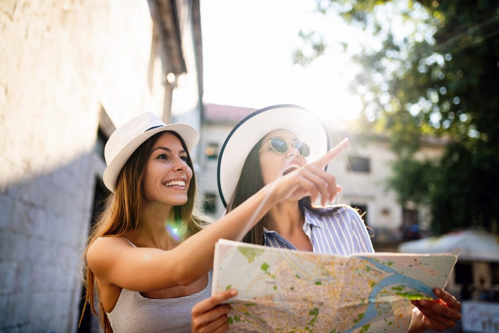 Young girl friends travelling summer vacation exploring to discover carefree lifestyle