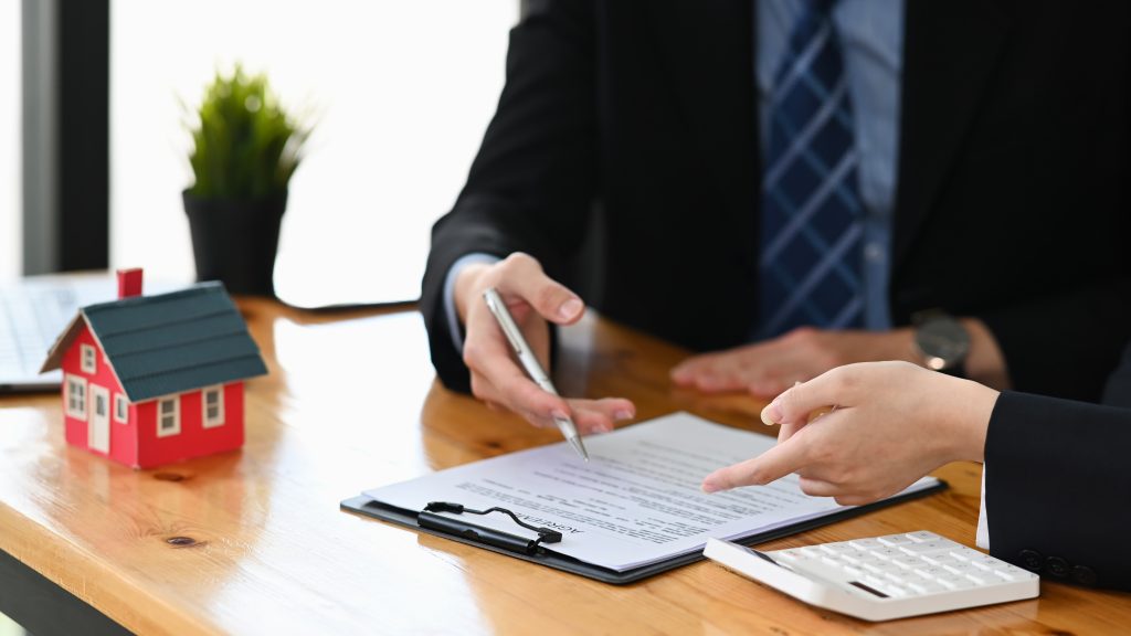 Cropped shot financial advisor consulting with client for real estate investment. Real estate investors, purchase and sales contracts concept.