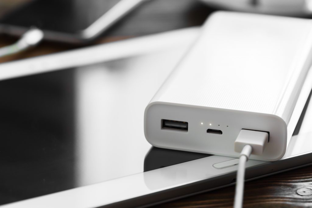 powerbank and cellphone on wooden table