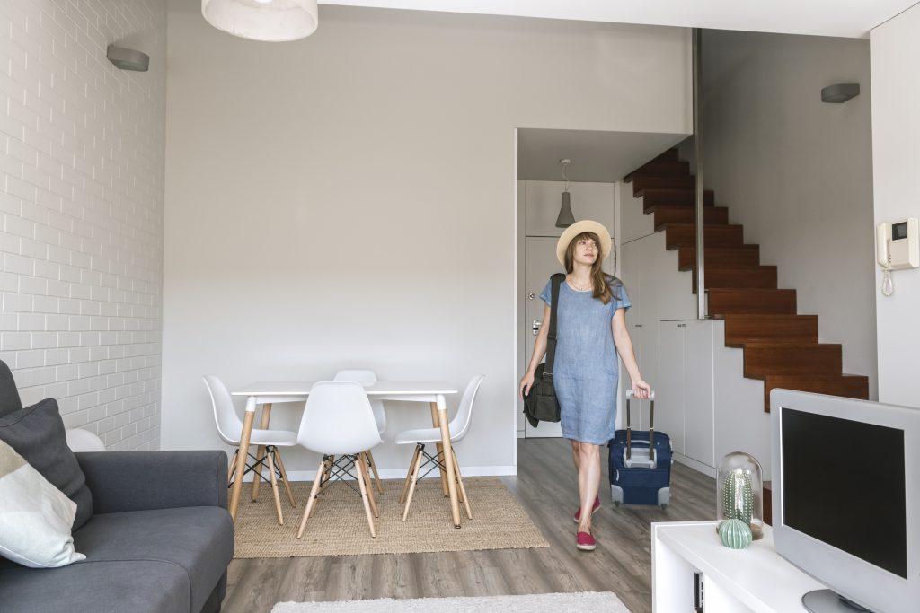 Tourist entering modern vacation home