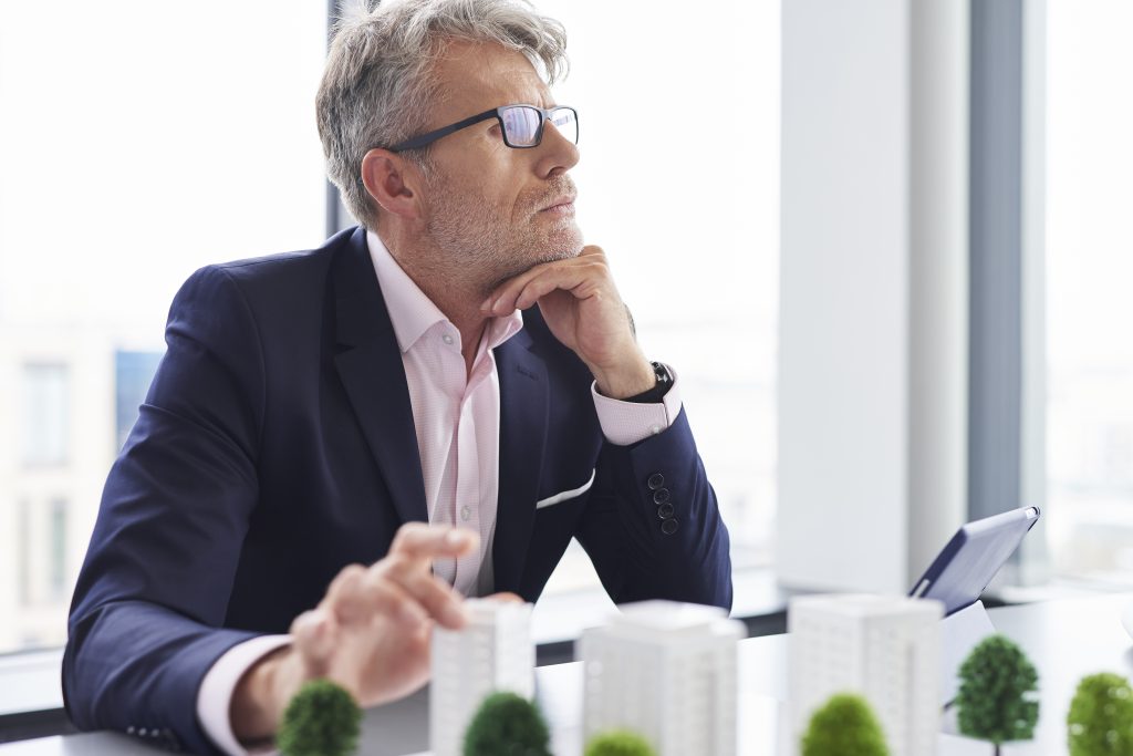 Busy senior businessman thinking about new solutions