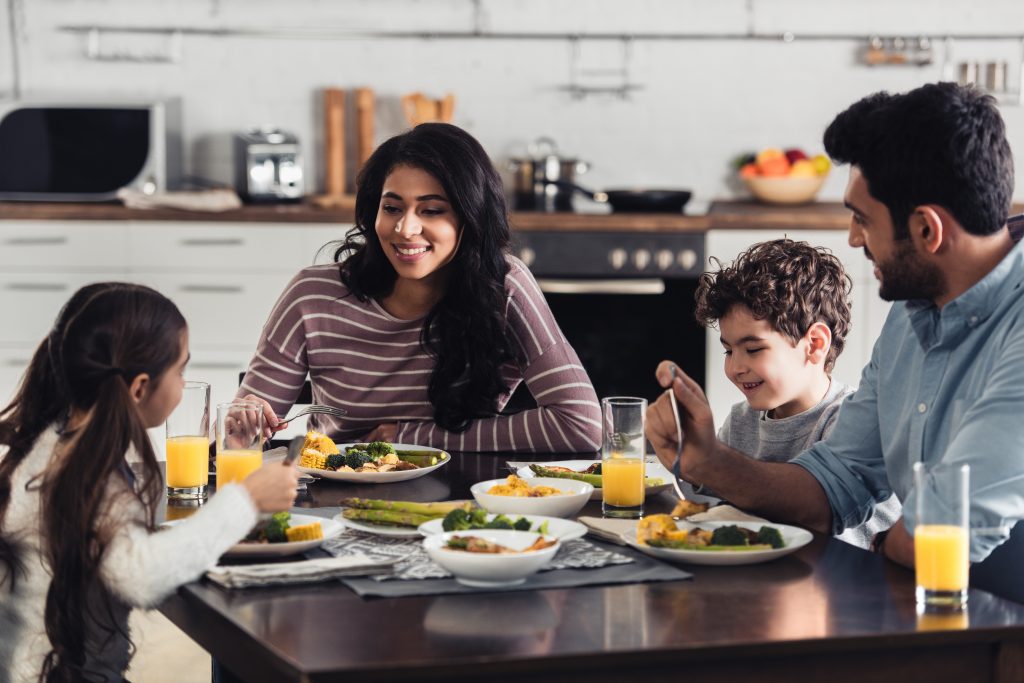 cheerful hispanic family having lunch at home