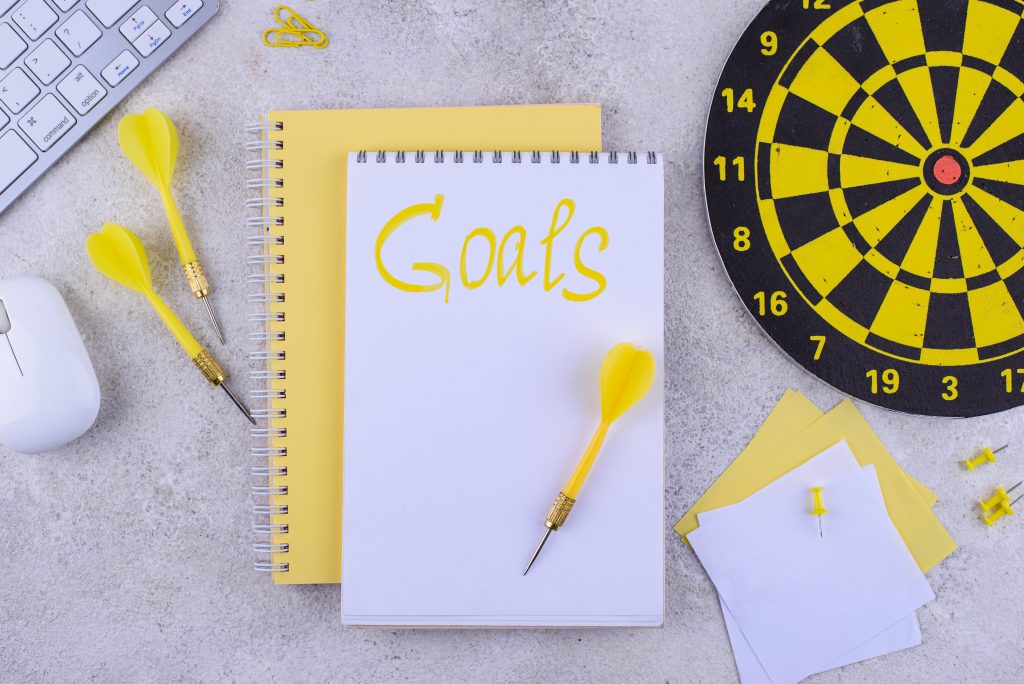 Target and goal concept with darts, arrows, and office accessories