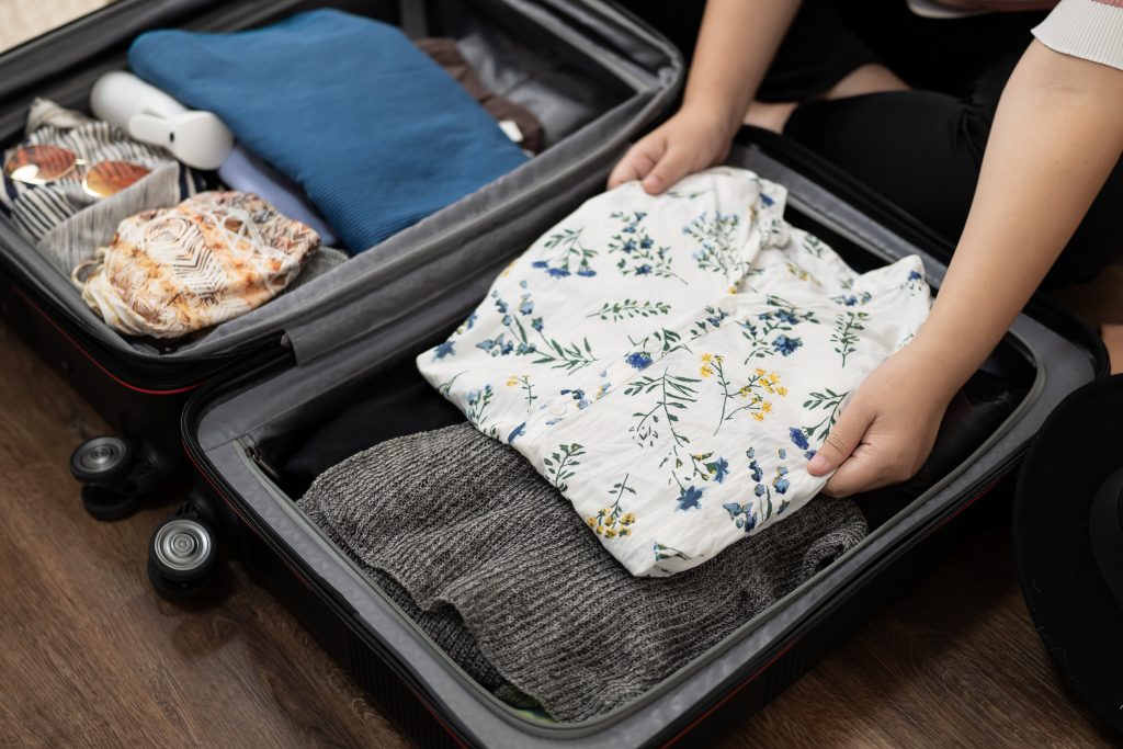 Woman packs baggage in suitcase for new journey packing a luggage travel plans vacation.