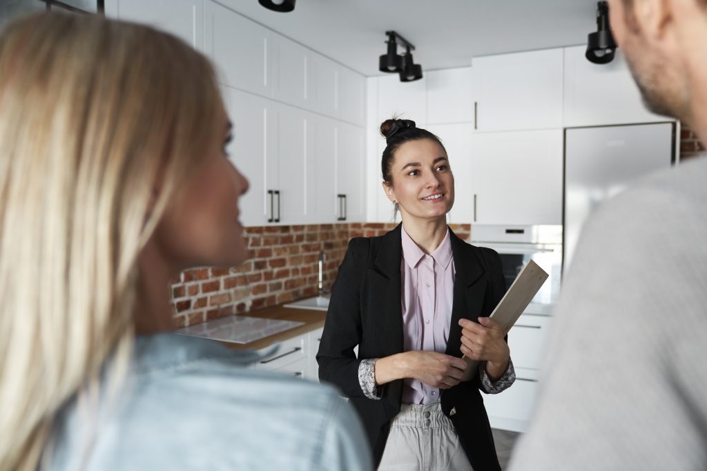 Real estate agent showing new apartment to a couple